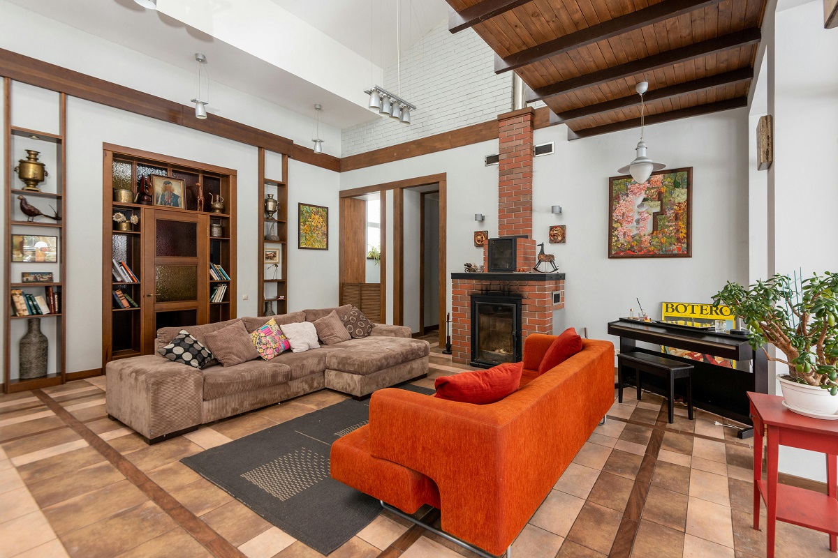 modern tudor style living room with a brick fireplace and hardwood flooring