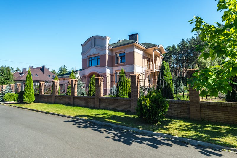 a house with a concrete, brick, and iron fence