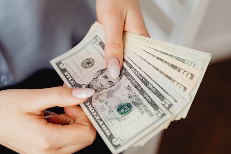 holding dollar bills